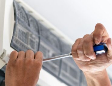 Technician repairing unit from AC repair companies in Dubai.