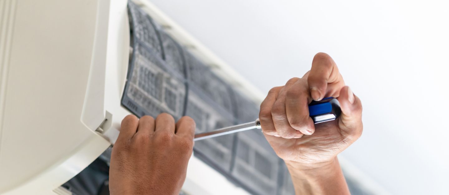 Technician repairing unit from AC repair companies in Dubai.