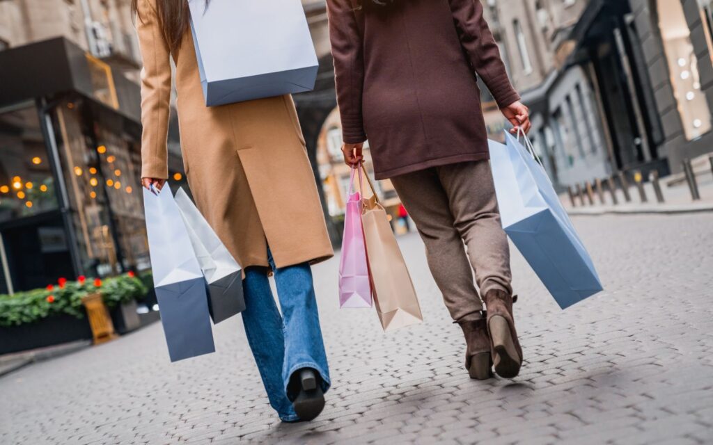 Happy shopper holding multiple packages.
