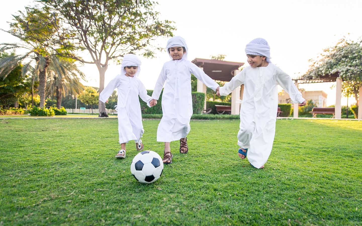 أطفال يلعبون الكرة في حديقة