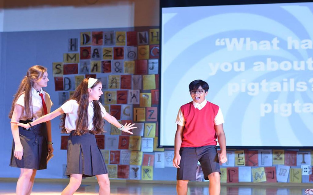 Students participating in a play at Al Bateen
