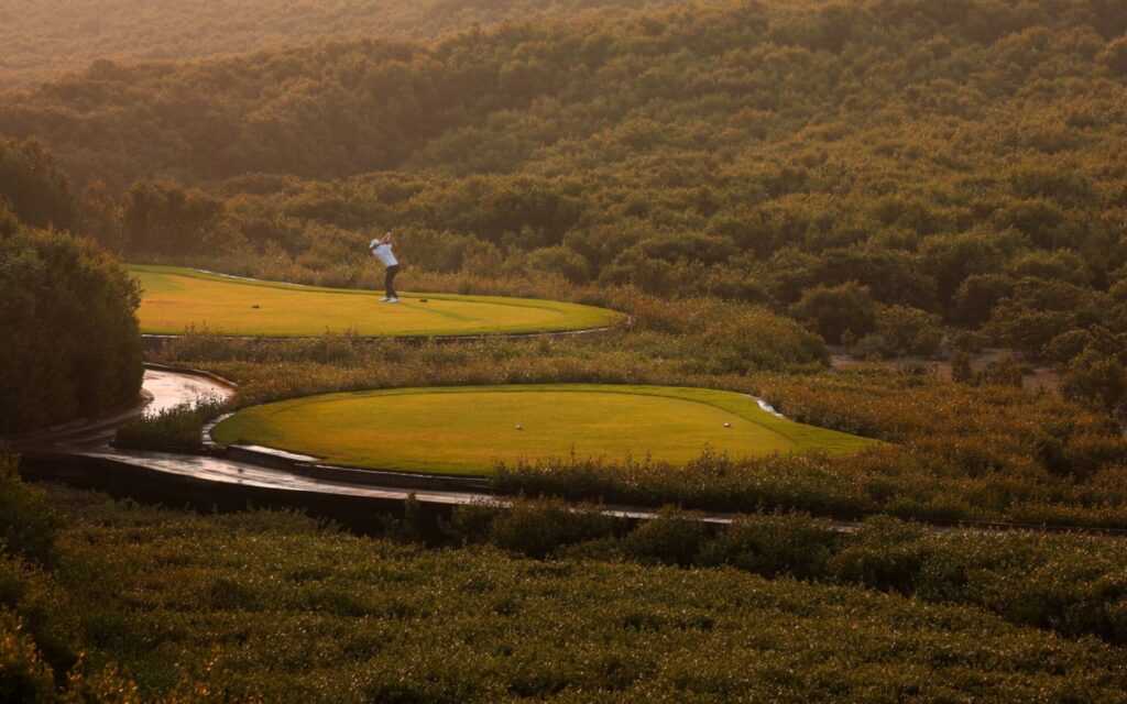man playing golf at al zorah golf club