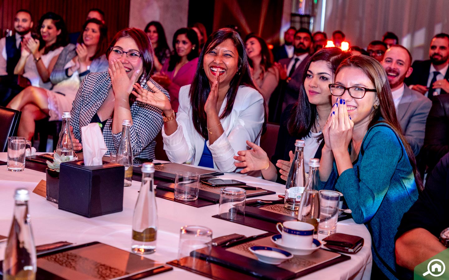 Team applauding at Bayut event