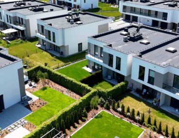 Aerial view of modern white suburban housing developments in areas to rent townhouses for couples in Dubai.