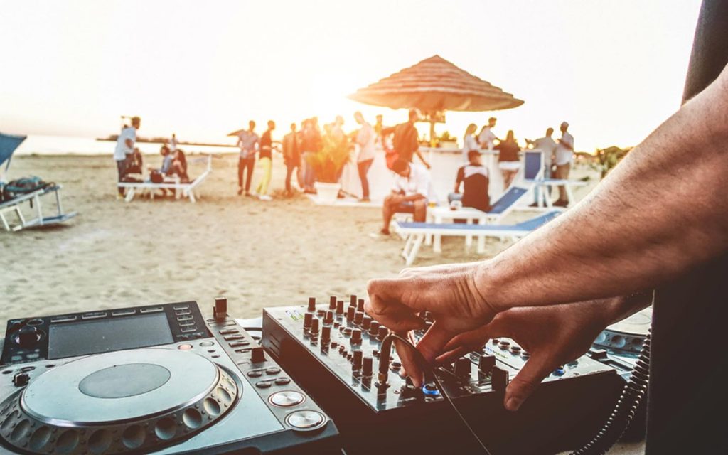 DJ playing music at an ourdoor beach bar in Dubai