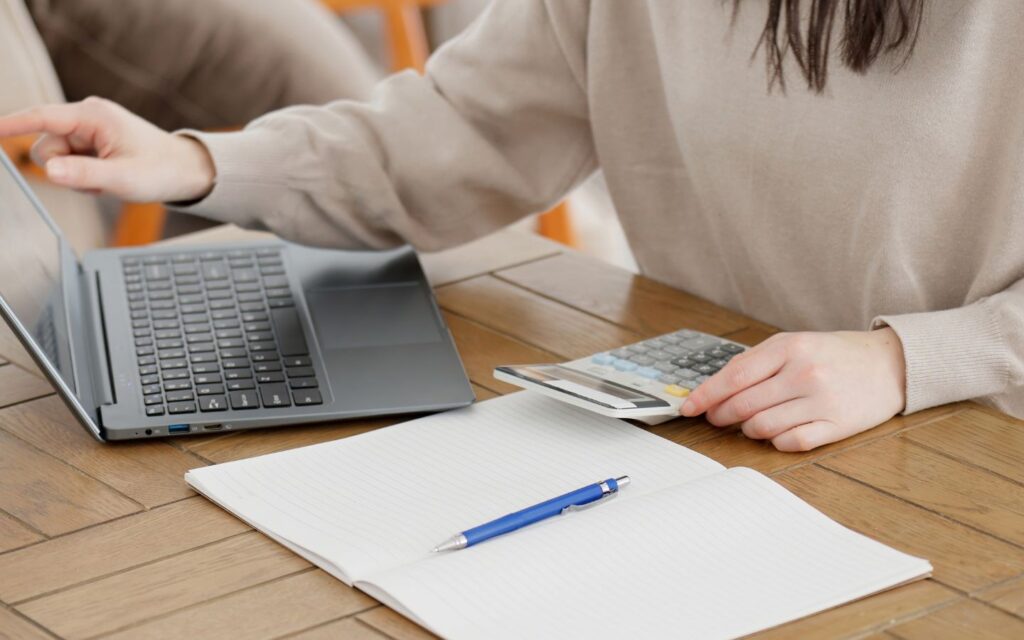 Student with laptop and calculator