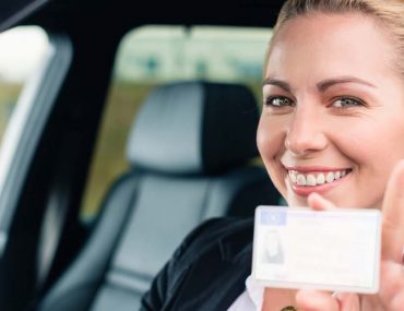 woman holding driving license