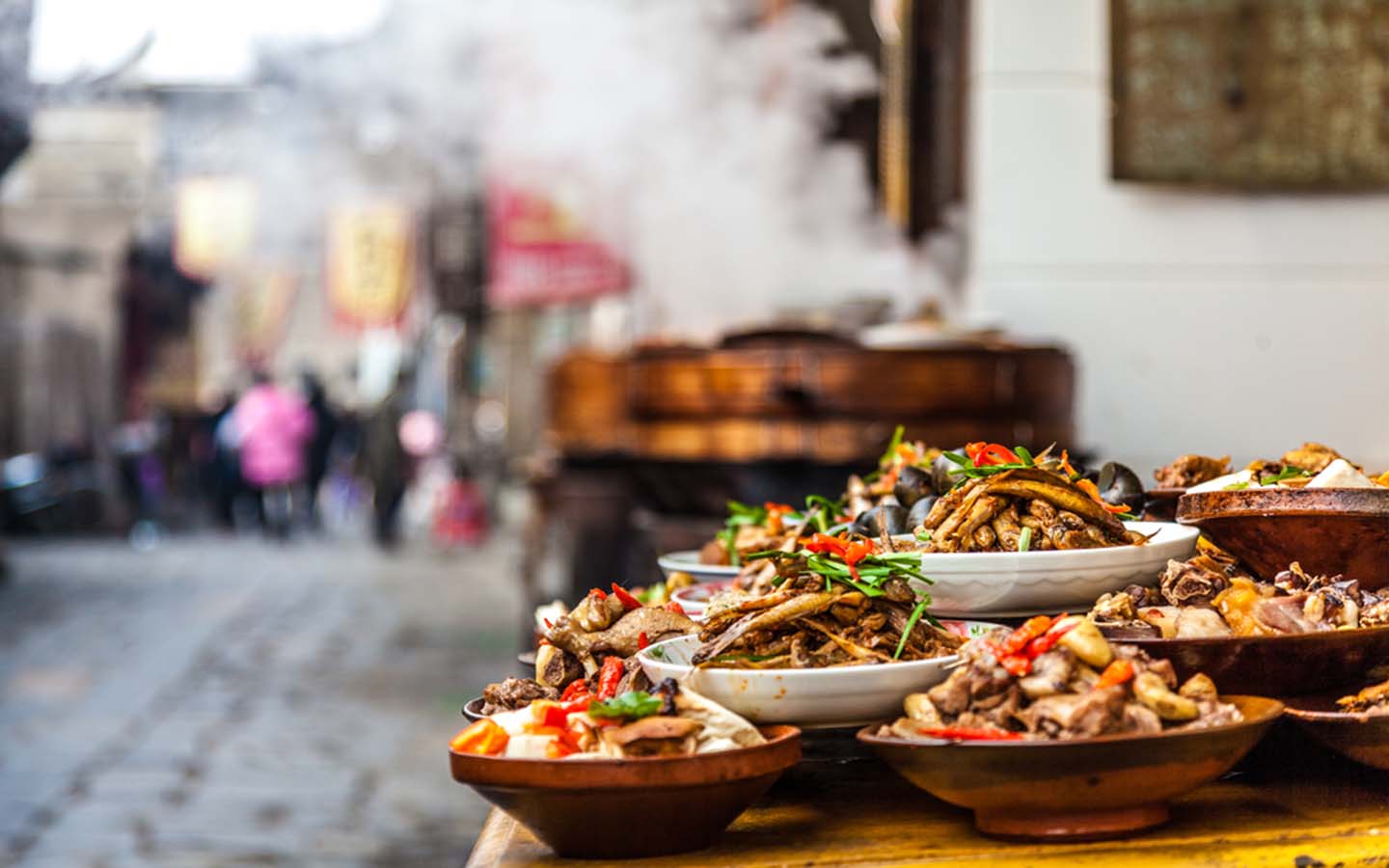 Variety of Chinese dishes placed on a roadside stall
