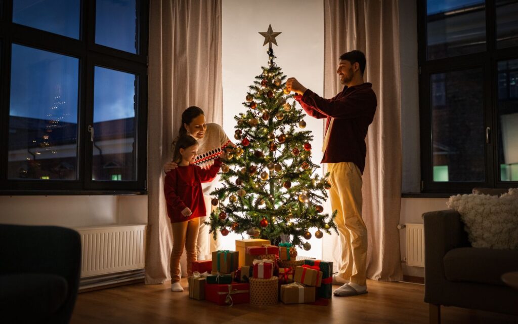 family enjoying quality time in Christmas tree decorations in Dubai