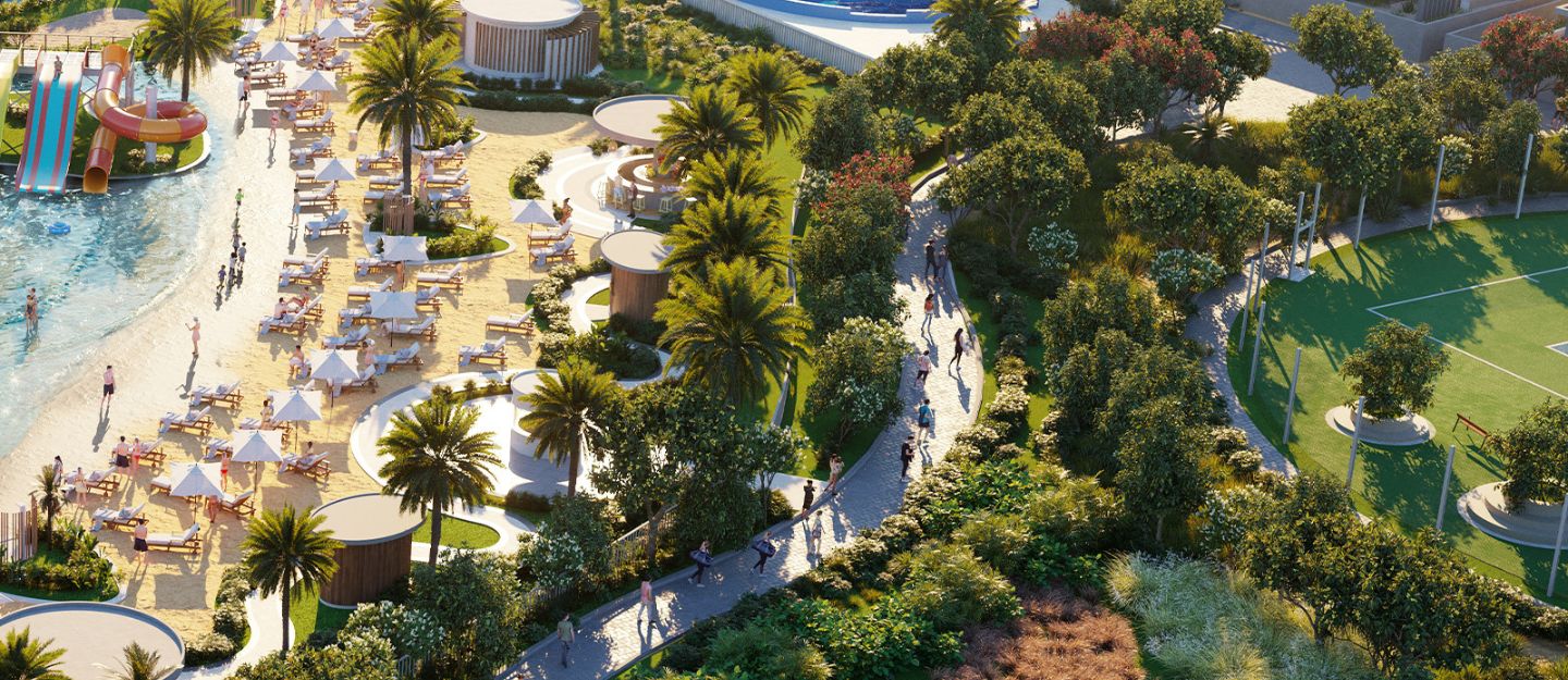 A scenic view of DAMAC Hills 2 featuring homes surrounded by greenery, lakes and walking paths.