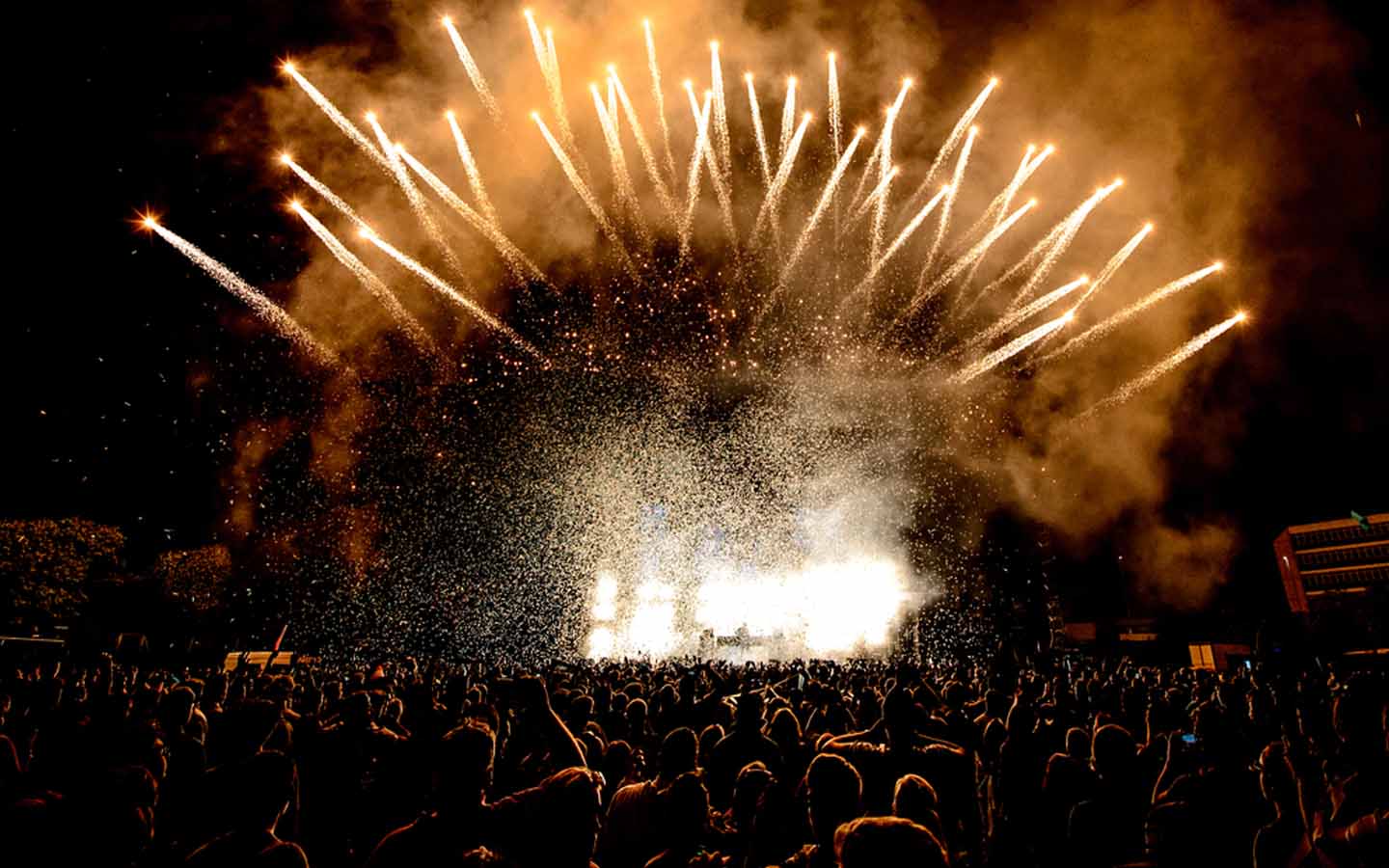 DJ, people and fireworks at a club