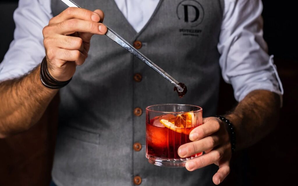 Bartender crafting signature cocktail in one of the best Best bars and nightclubs in Downtown Dubai
