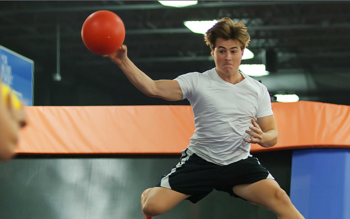 person hitting a dodgeball at Sky Zone Dubai