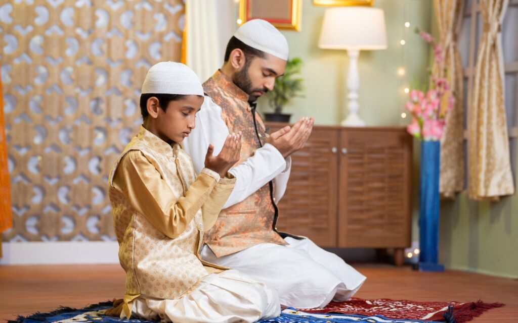 father and son performing Eid Salah at home