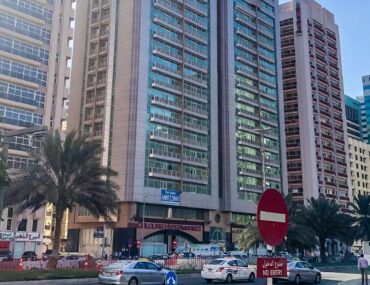 High-rise residential and commercial towers along Electra Street, Abu Dhabi, with LuLu Supermarket signage visible at street level.