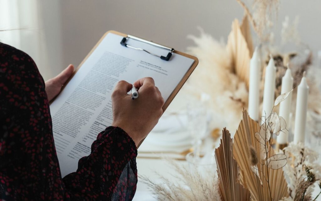 A professional planner holding a detailed event itinerary while coordinating with event management companies in Abu Dhabi.