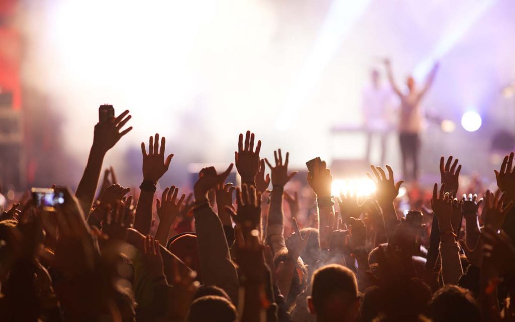 people cheering at a concert