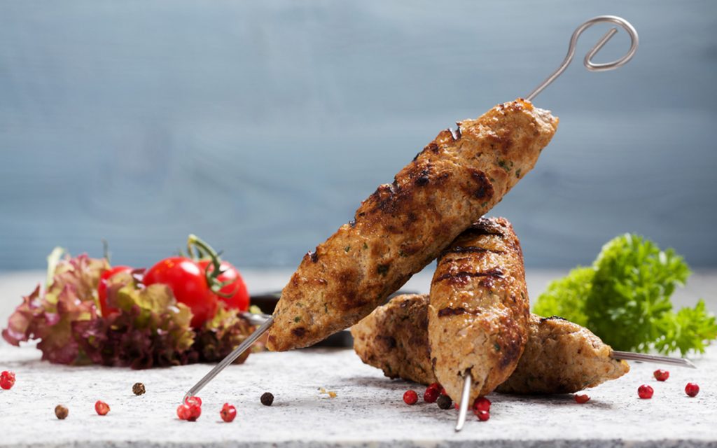 Grilled lamb kufta served over skewers