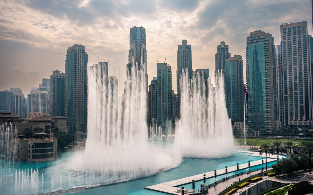 The Dubai Fountain in Downtown Dubai performing a choreographed water and light show with jets of water soaring against the city skyline.