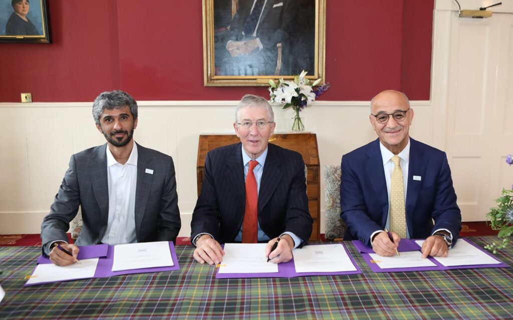 men signing documents