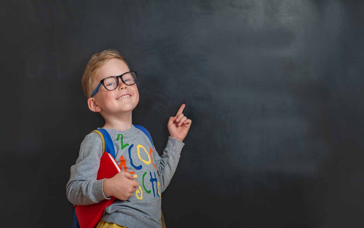 A student pointing towards greenboard