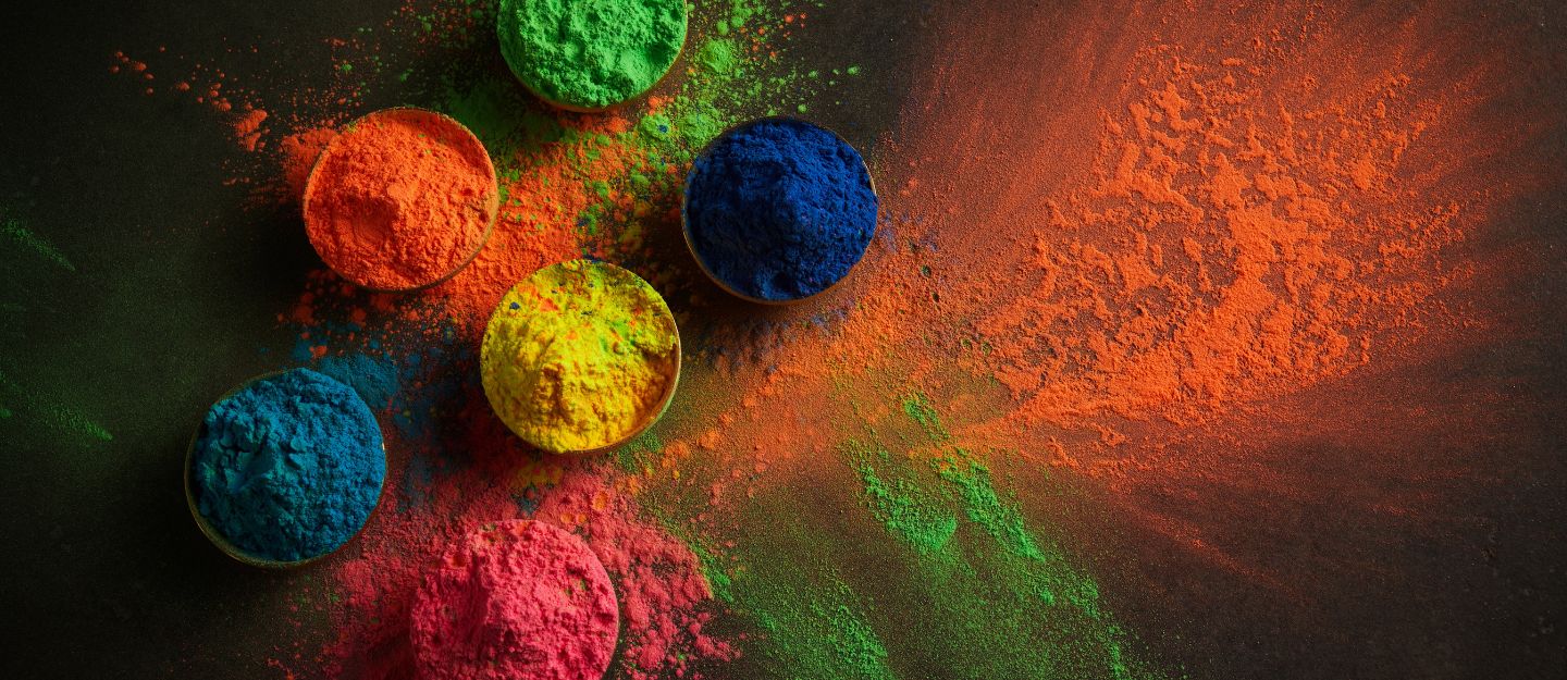 Brightly coloured powders arranged in bowls ready for throwing during the Holi festival in Dubai