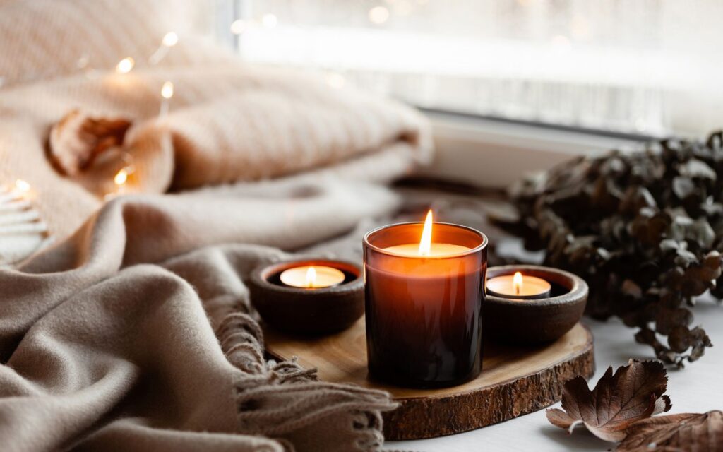 Softly glowing candles enhance a room, offering a peaceful home environment idea.