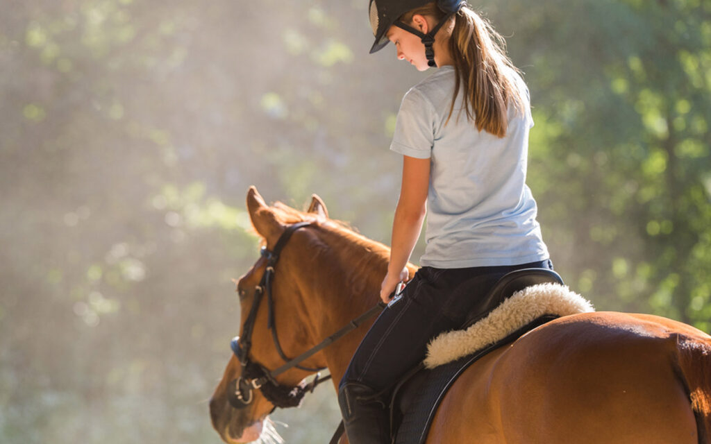 Girl learning to ride a horse in UAE