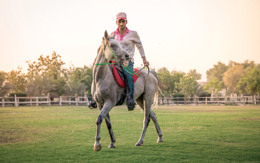 Man learning to ride a horse Abu Dhabi