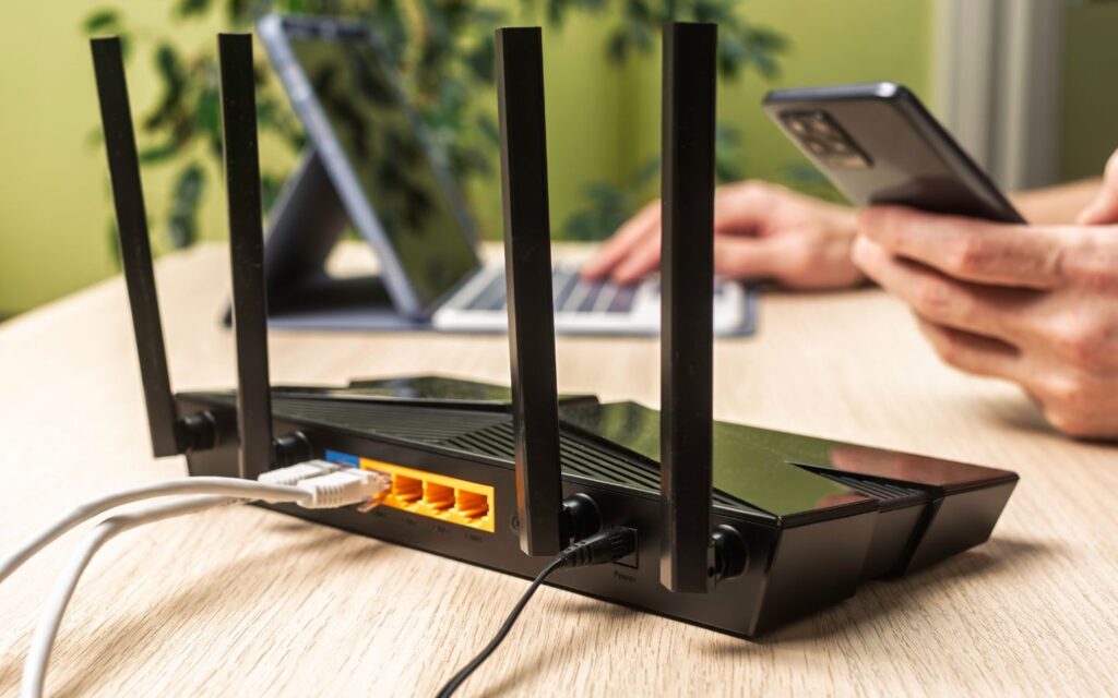 Professional technician installing a fiber optic modem during a successful home internet relocation process.