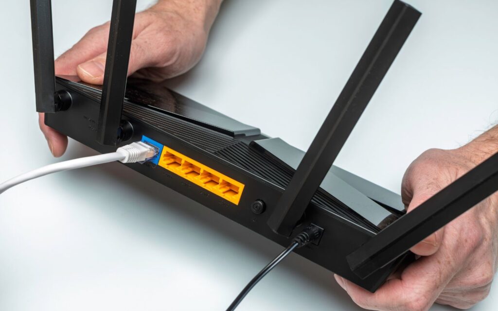 Customer service unplugging internet device to move wifi connection safely.