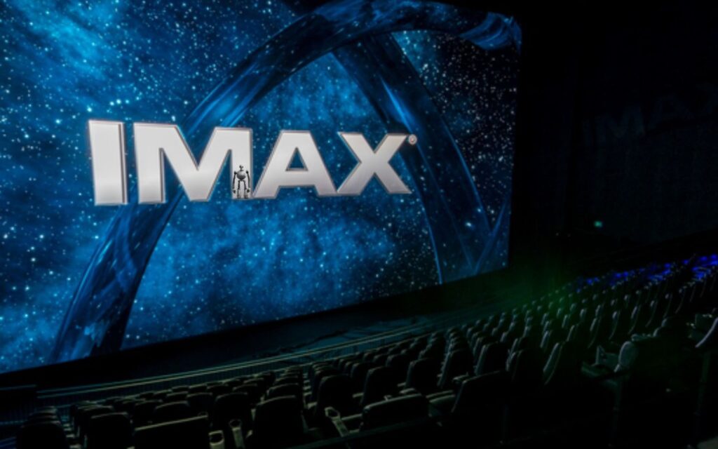 Immersive IMAX cinema screen with seating