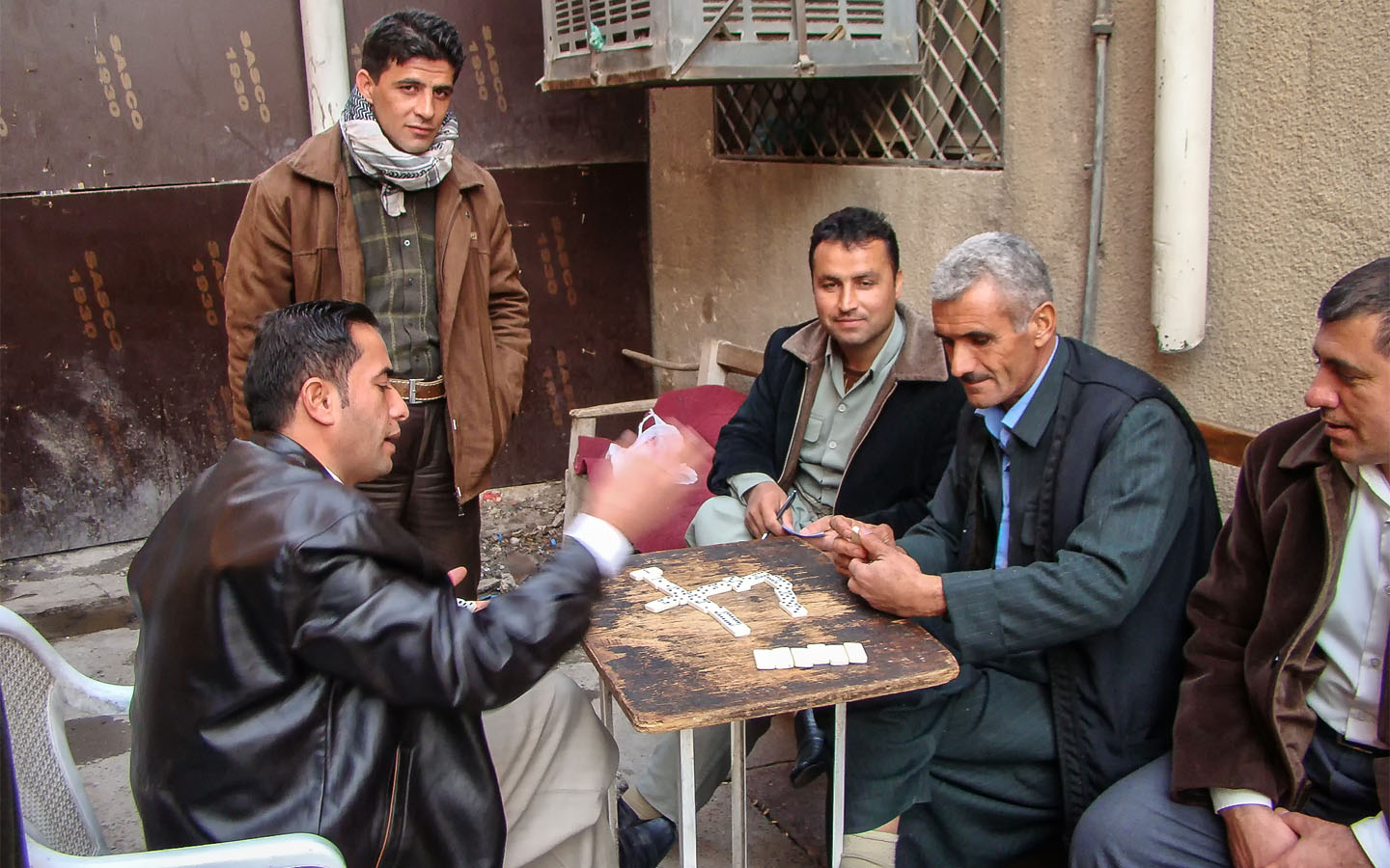 Iraqi men playing games in a bazar
