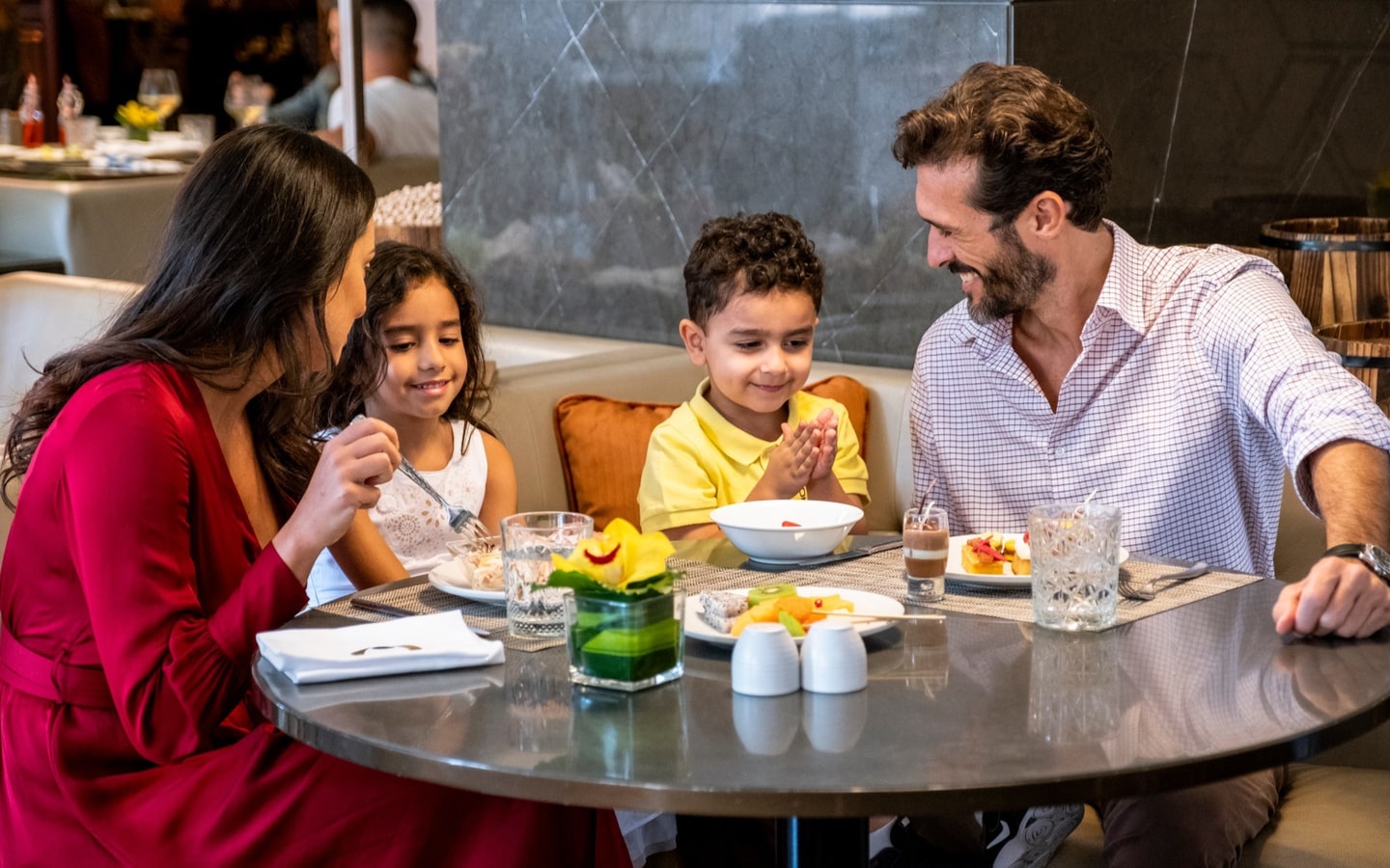 Parents and two kids and Olea restaurant, part of a Dubai NYE Hotel deal