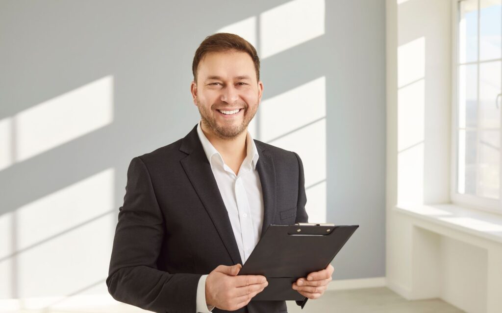 Broker smiling with clipboard in hand