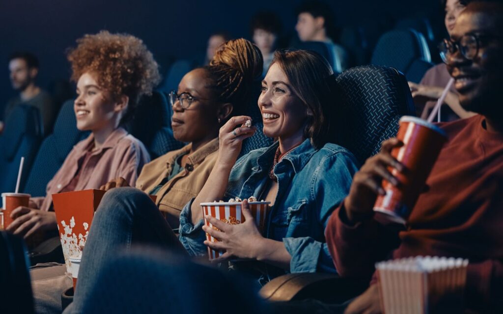 friends enjoying movie in Cinema
