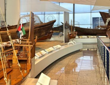 Traditional boats and maritime artefacts displayed inside a museum gallery