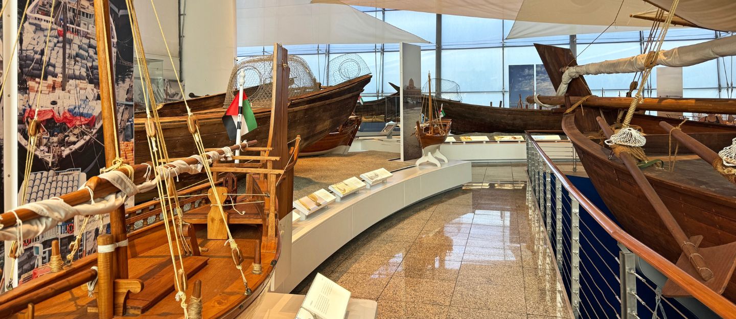 Traditional boats and maritime artefacts displayed inside a museum gallery