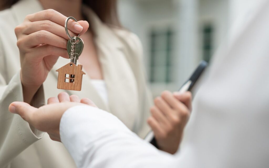 real estate agent giving keys to home owner