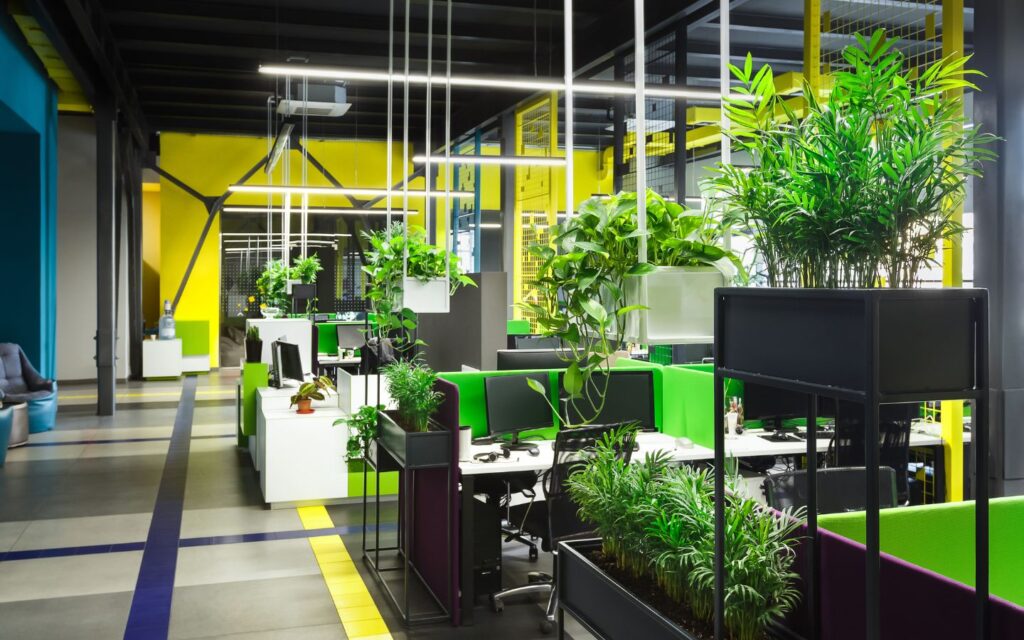 Modern office space filled with indoor plants, natural light and biophilic design elements.
