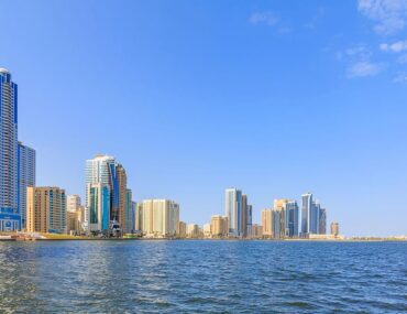 Modern residential towers in Sharjah showcasing chiller-free apartments for rent