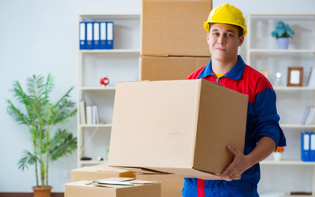 Man holding a box, offering house moving services in Dubai