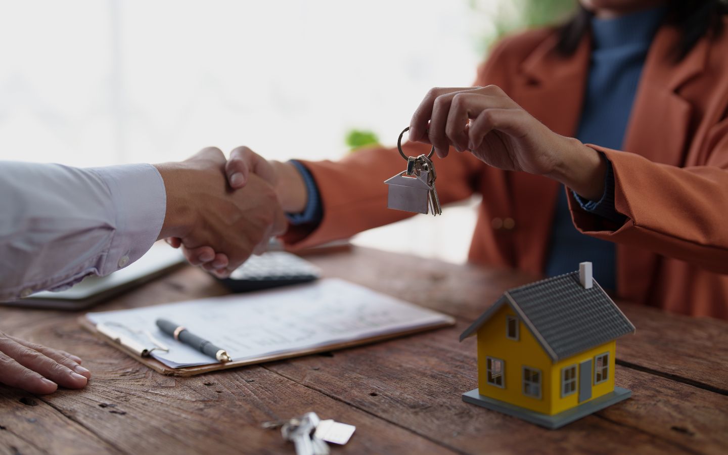 Property manager signing a contract with a client in an office