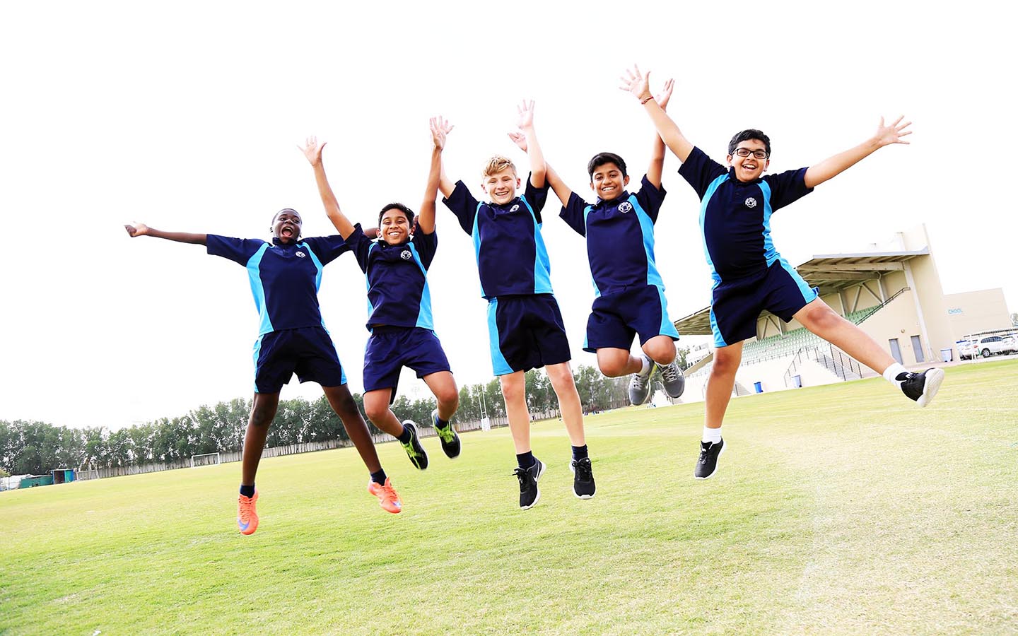 School kids group jumping and posing for photo