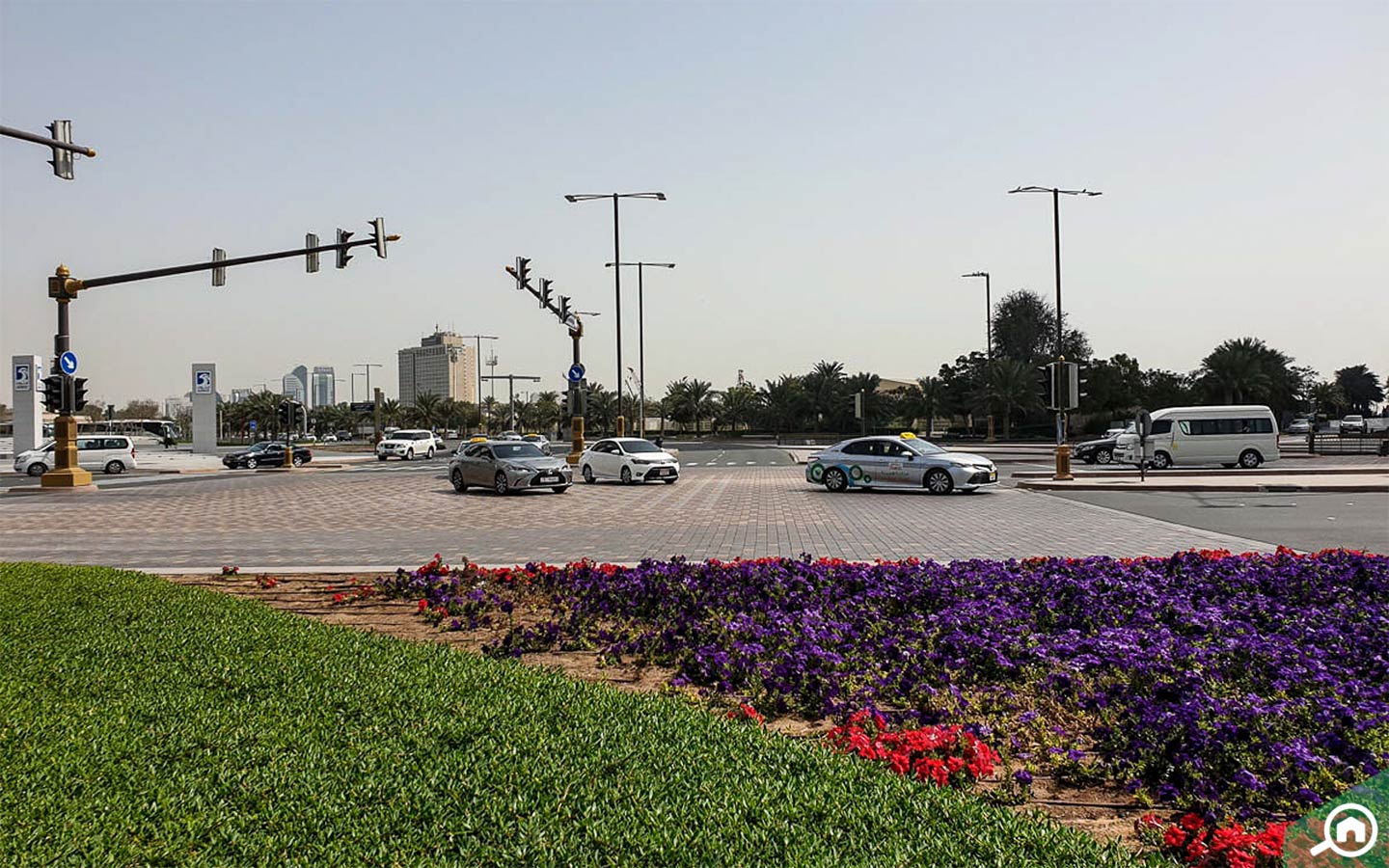 Traffic intersection in Abu Dhabi with cars and taxis