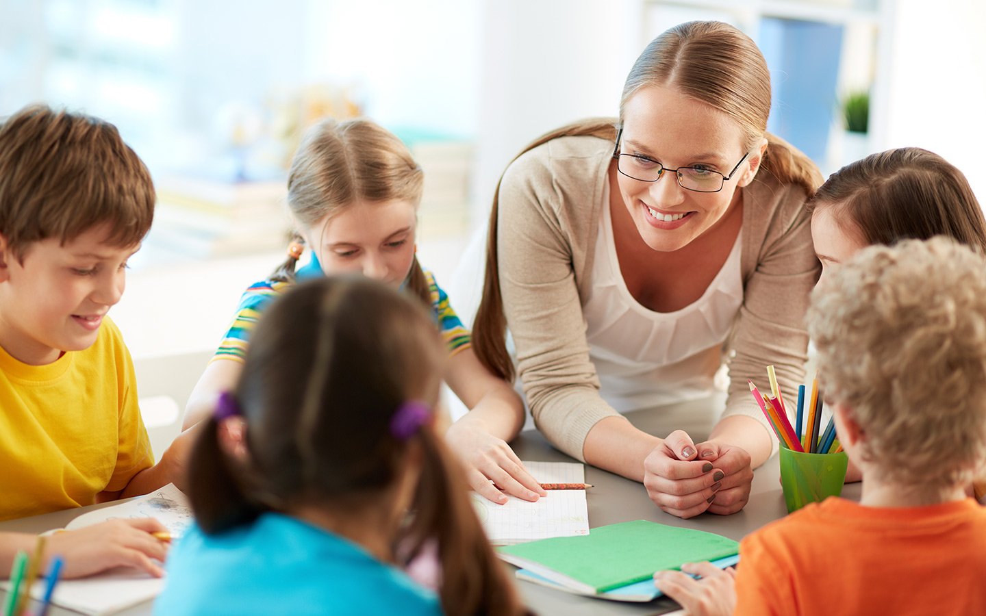 Teacher with a group of students at an Umm Al Quwain school