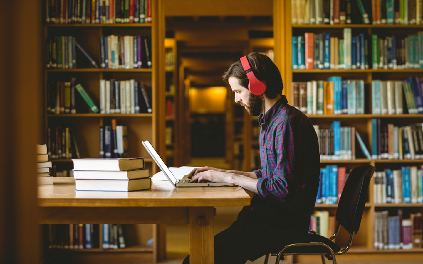 A man making assignment at a library in a university