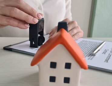 person stamping a building completion certificate