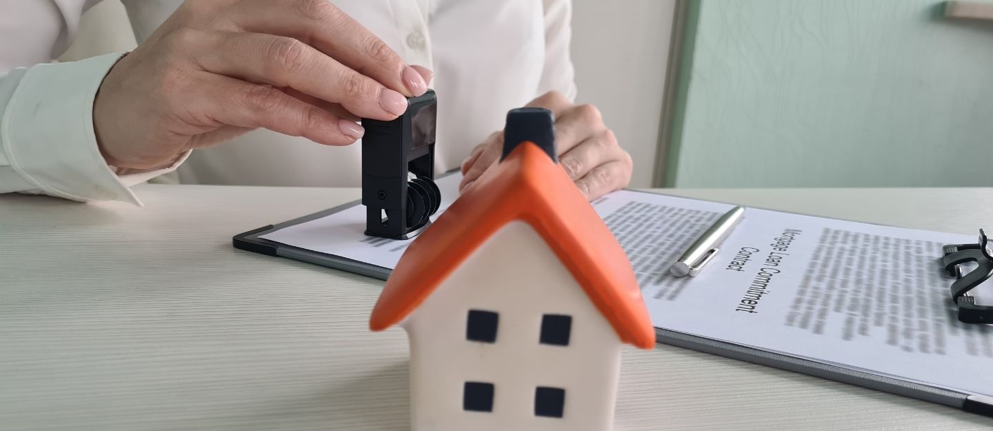 person stamping a building completion certificate