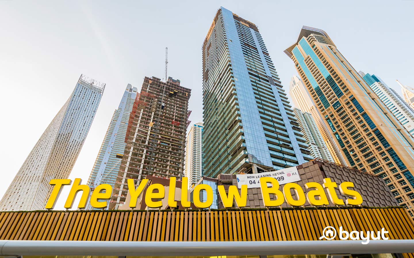 Singthsseing in Dubai Marina with Yellow Boats